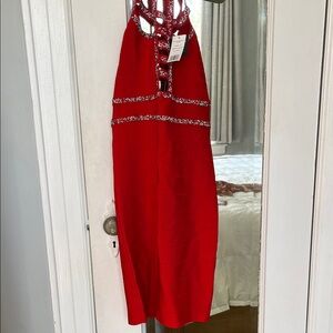 Bebe Red mini/Midi dress with Patterned Accents. Red and silver crystals.